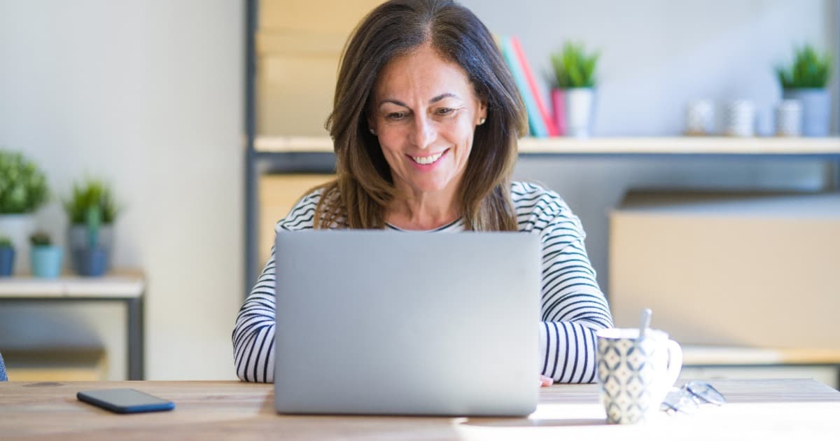 woman at desk looking at Logos 10 Bible app packages