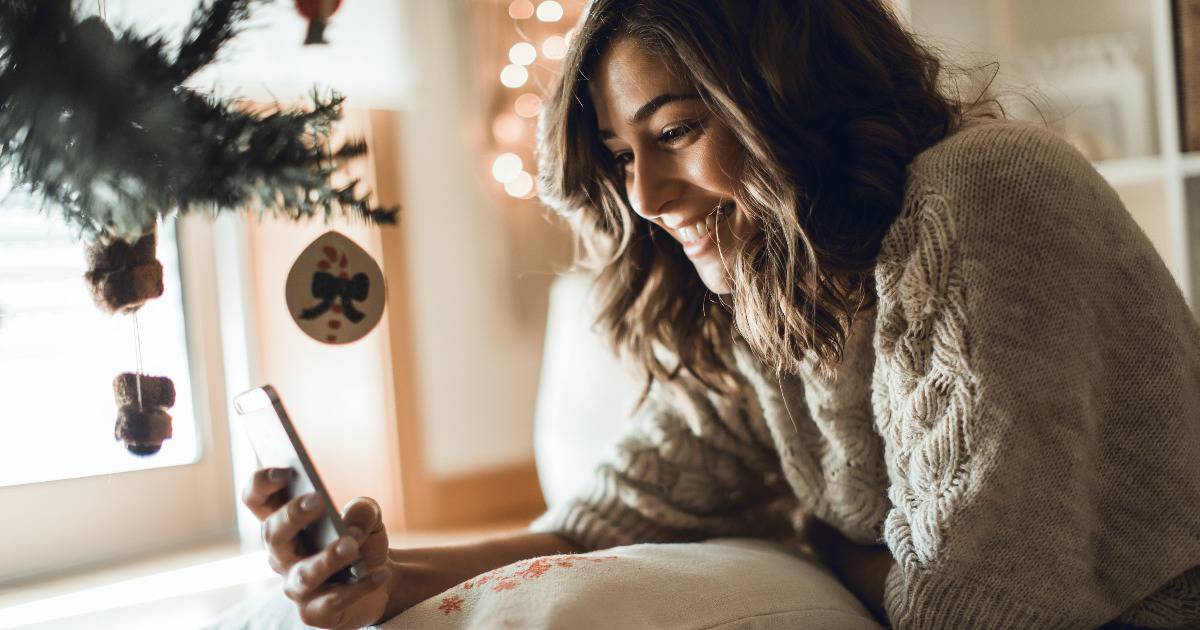 woman looking at a church's social media at Christmas